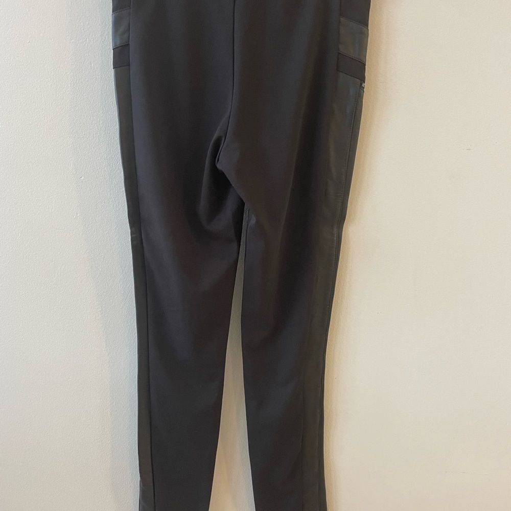 Black pants with faux leather accents. Never worn no tags